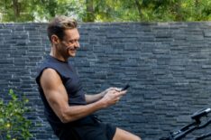 Ryan Seacrest exercising on a stationary bike at his home