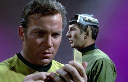 William Shatner as Captain James T. Kirk speaks into his communicator with Leonard Nimoy as Mr. Spock in the background in 'Star Trek' Season 3 Episode 1, 'Spock's Brain'