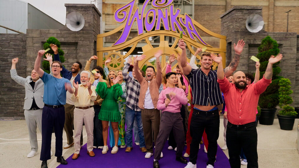 'Wonka's The Golden Ticket' contestants wave at the gates of a recreation of Wonka's factory.