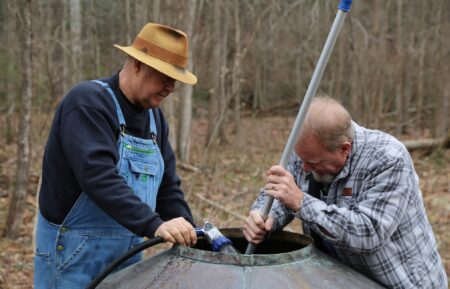 Mark Ramsey and Eric “Digger” Manes cleaning the inside of a still.