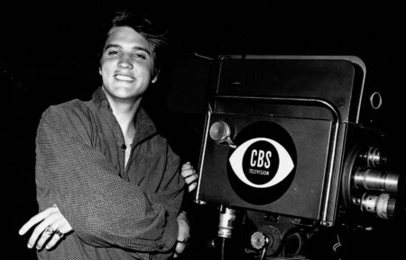 American singer and actor Elvis Aaron Presley (1935 - 1977) stands with his arms crossed by a television camera on the night of his first appearance on 'The Ed Sullivan Show,' CBS Television City studios, Los Angeles, California, September 9, 1956.