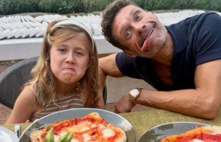 Ryan Seacrest and his niece, Flora, eating pizza