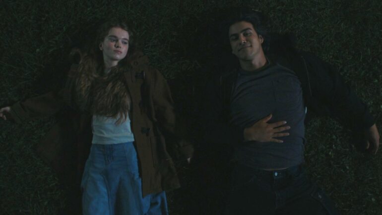 Carrie and Tommy lay on the grass and look at the stars in 'Carrie' Season 1