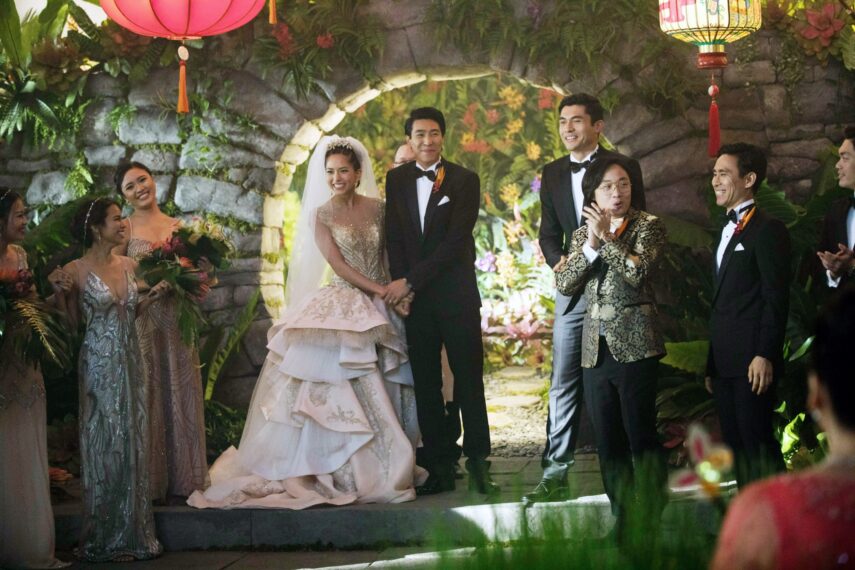CRAZY RICH ASIANS, Sonoya Mizuno (center left), Chris Pang (center right), Henry Golding (back right), Jimmy O. Yang (gold jacket), 2018.