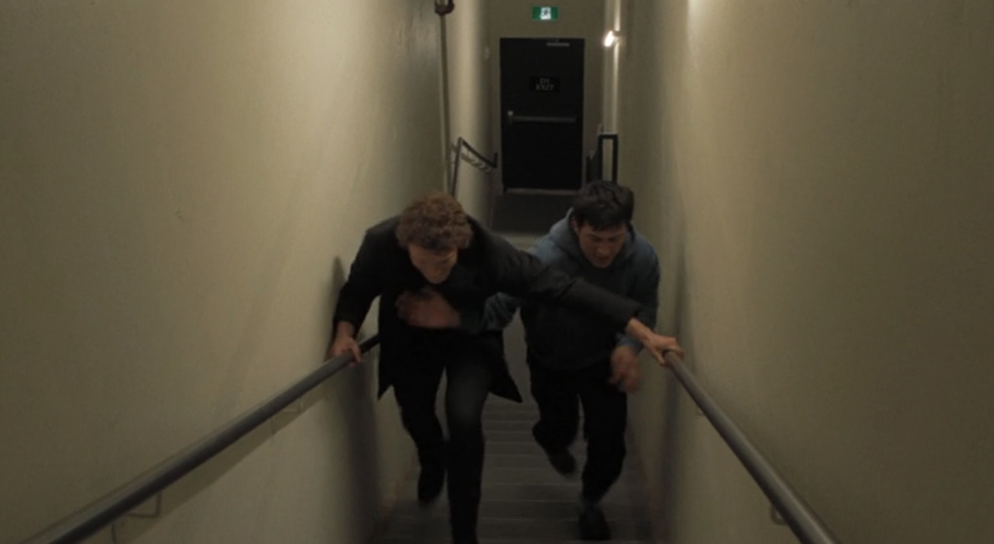 Ilya and Shane racing up the stairs in 'Heated Rivalry' Season 1 Episode 2