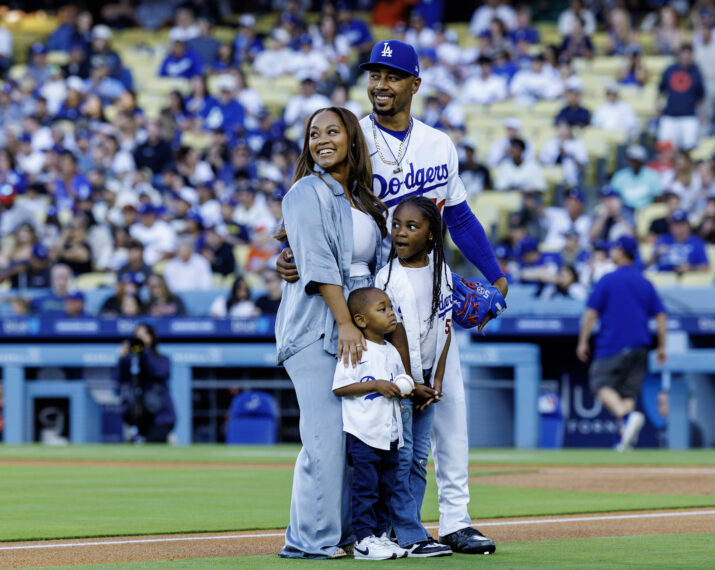 Los Angeles Dodgers shortstop Mookie Betts (50) poses on the field with his family on his bobblehead night before the game against the Baltimore Orioles at Dodger Stadium