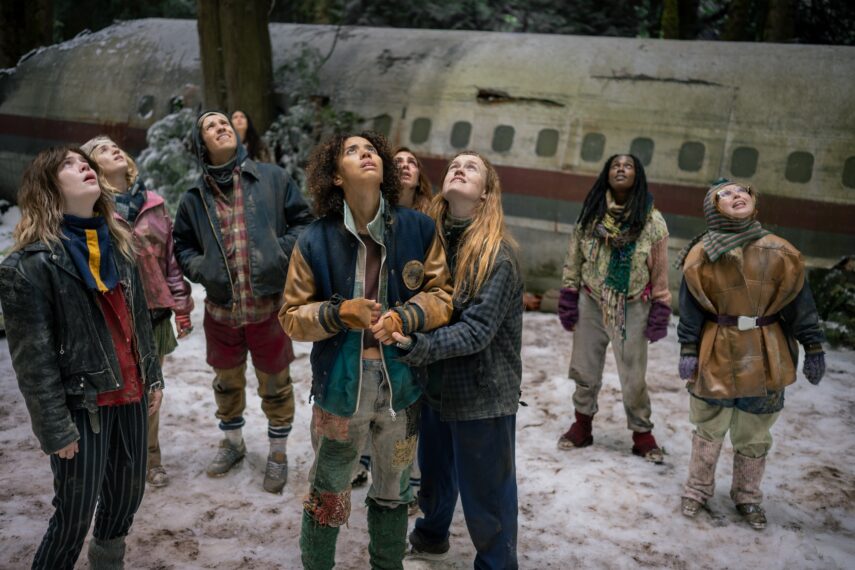 L-R: Sophie Thatcher as Teen Natalie, Jenna Burgess as Teen Melissa, Kevin Alves as Teen Travis, Courtney Eaton as Teen Lottie, Jasmin Savoy Brown as Teen Taissa, Sophie Nélisse as Teen Shauna, Liv Hewson as Teen Van, Nia Sondaya as Teen Akilah and Samantha Hanratty as Teen Misty in 'Yellowjackets' Season 4 Episode 8